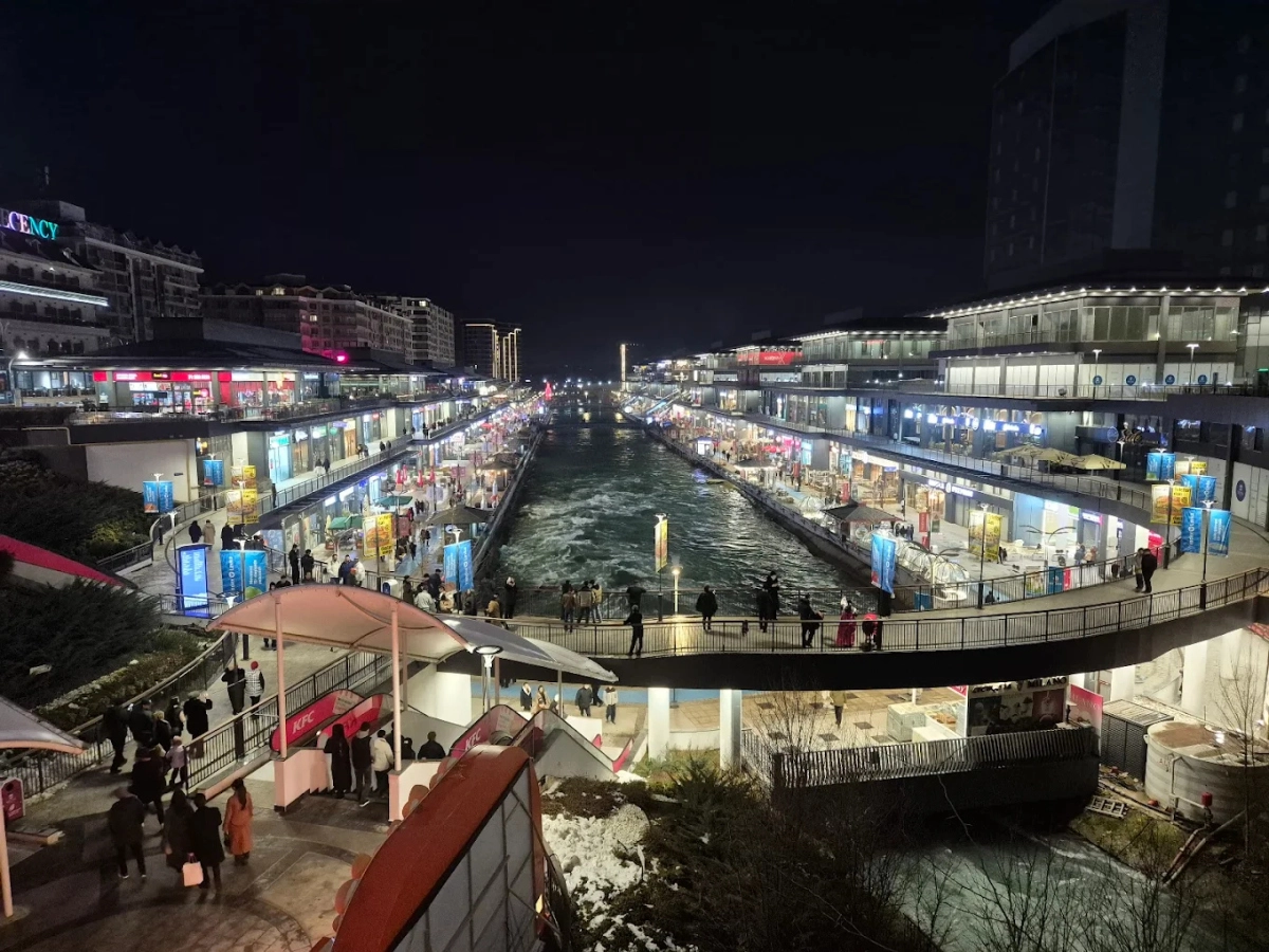 Seoul Mun area in Tashkent with evening lights, shops and pedestrian street