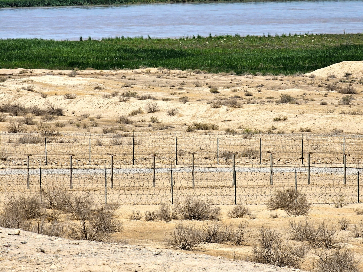 Archaeological landscape near ancient Termez Dry archaeological landscape near ancient Termez with fenced sandy terrain