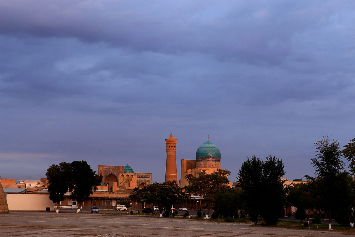 Evening light over old Bukhara with Kalyan Minaret and blue dome