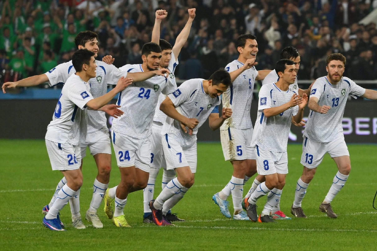 Uzbekistan football players celebrating on the pitch