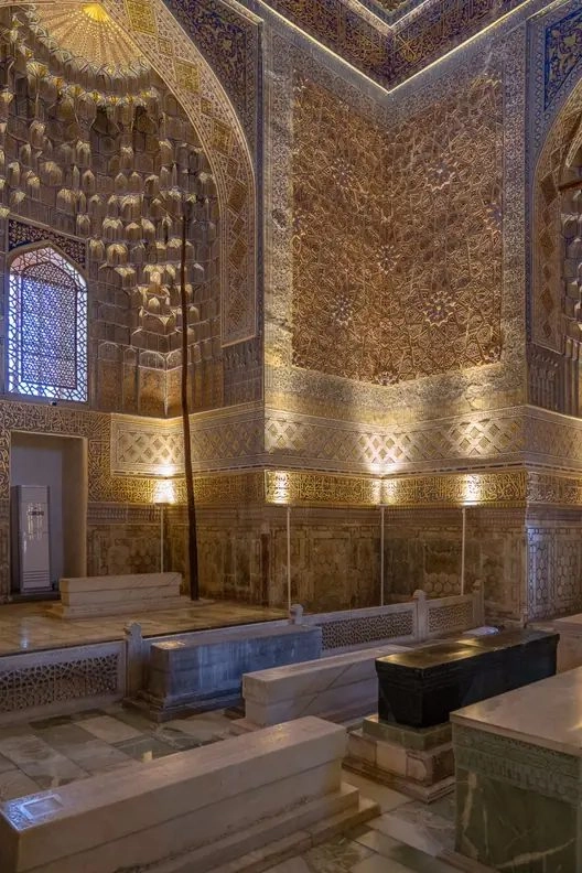 Golden interior and tombstones inside Gur-e Amir Mausoleum in Samarkand