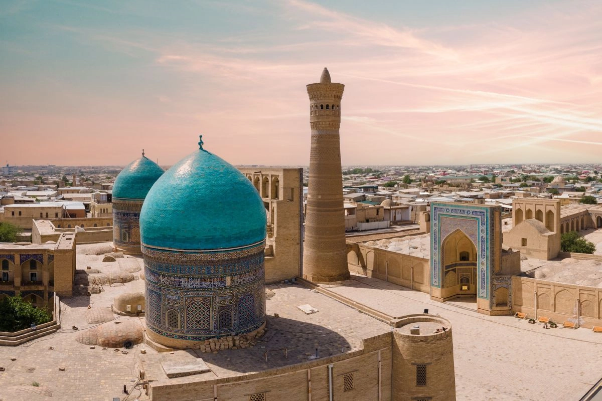 The turquoise domes of Mir-i Arab Madrasa and the Kalyan Minaret in Bukhara