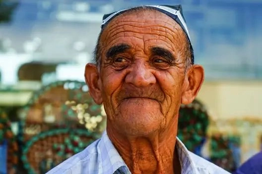 Portrait of a man wearing a traditional skullcap