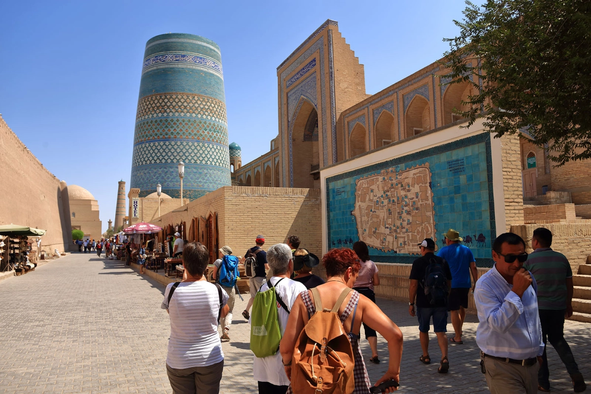 Guided walking tour approaching Kalta Minor and the historic streets of Ichan Kala in Khiva Uzbekistan
