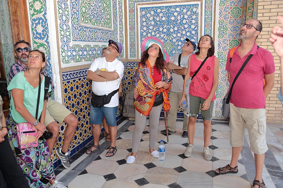 Tourists exploring the stunning interior architecture of the Tashkent Museum of Applied Arts
