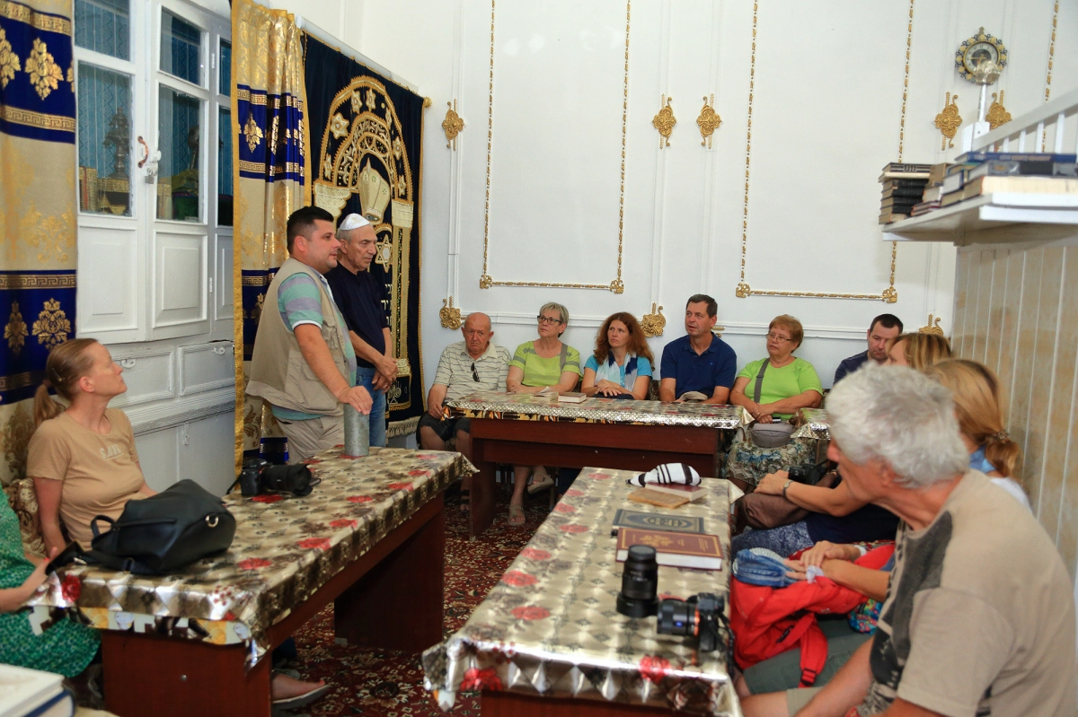 Local home programme in Bukhara Travellers seated inside a local Bukhara home during a cultural food programme