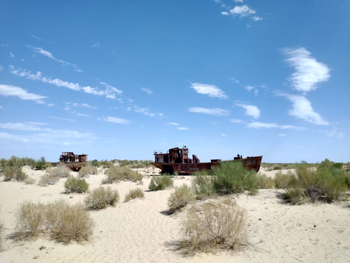Rusted ships at Muynak Ship Cemetery Rusted ships standing in sand at Muynak Ship Cemetery