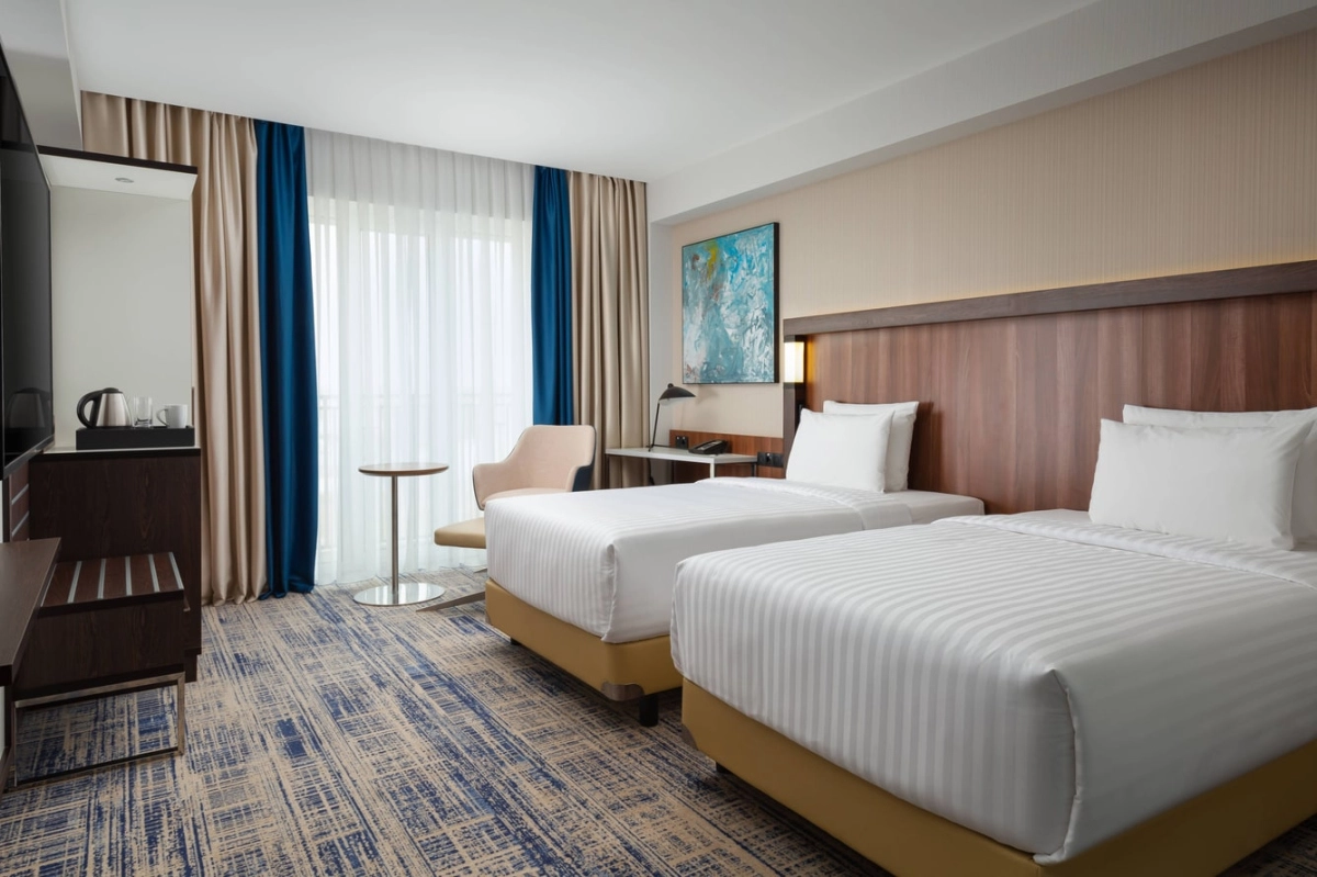 Two separate beds in a Courtyard by Marriott Tashkent twin guestroom