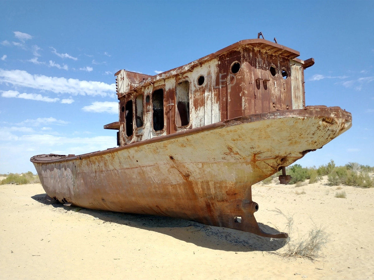 Muynak Ship Cemetery on the former Aral Sea seabed Rusted fishing boat at Muynak Ship Cemetery on the former Aral Sea seabed