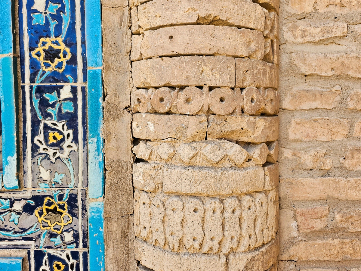 Tile and carved brick detail in Termez Close-up of blue glazed tile and carved brick detail on a historical monument in Termez