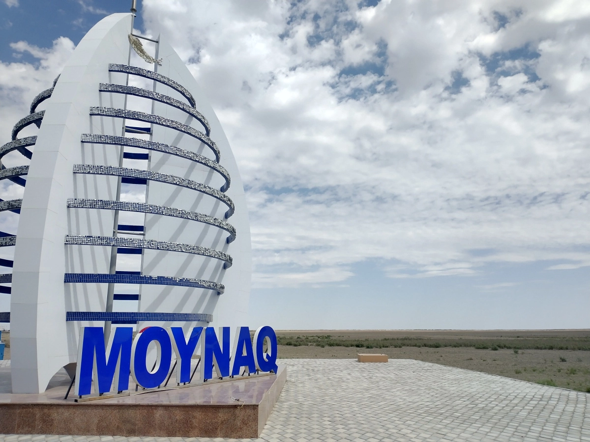 Moynaq landmark near the former Aral Sea seabed Moynaq sign and white sail monument beside the former Aral Sea landscape
